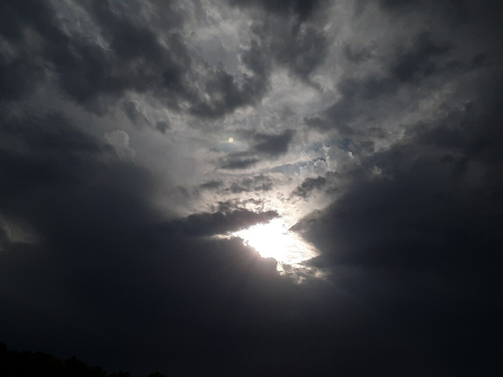 Sun breaking through dark clouds