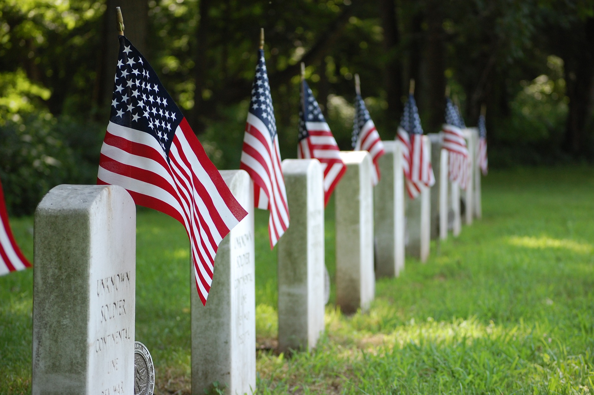 American flags beside gravestones