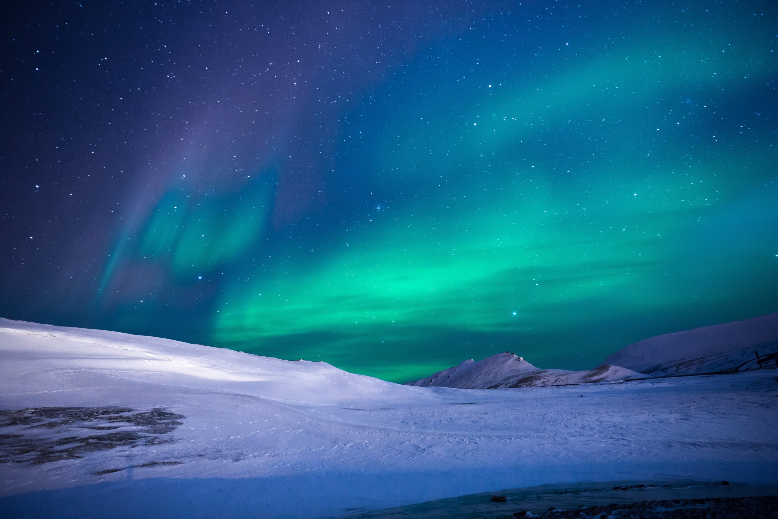 Northern Lights over a snow covered mountian